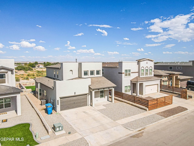 view of front of property with a garage and central AC unit