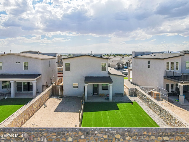 rear view of house with a yard and a patio