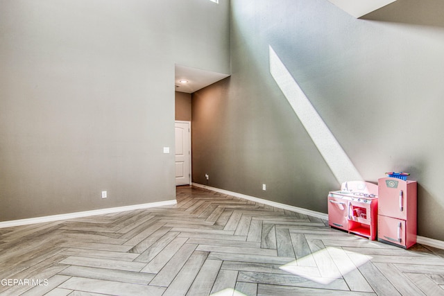 additional living space featuring parquet flooring