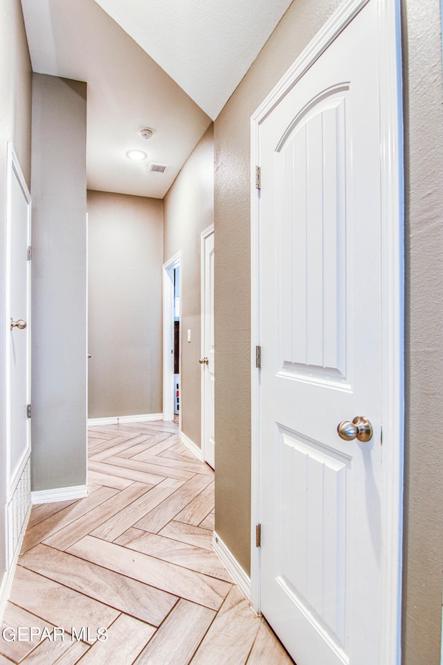 corridor featuring light parquet floors