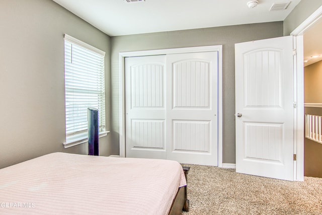 carpeted bedroom featuring a closet