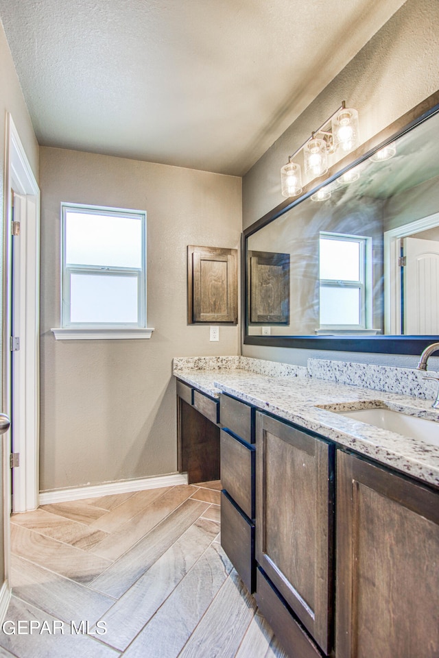 bathroom featuring a textured ceiling and vanity