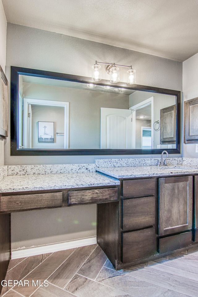 bathroom with hardwood / wood-style flooring and vanity