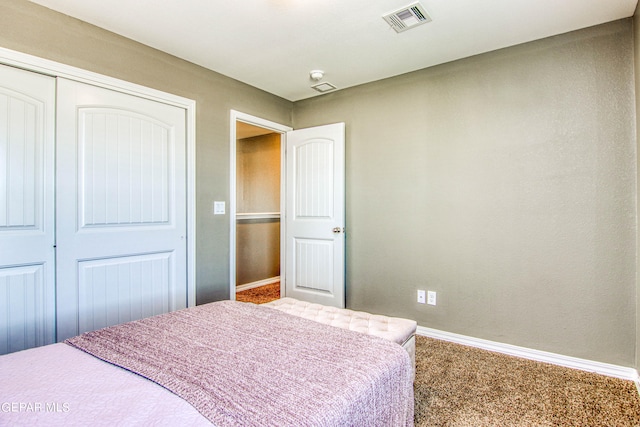 carpeted bedroom with a closet