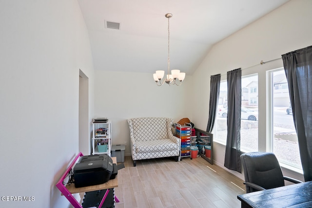 interior space featuring a notable chandelier, lofted ceiling, and light hardwood / wood-style floors