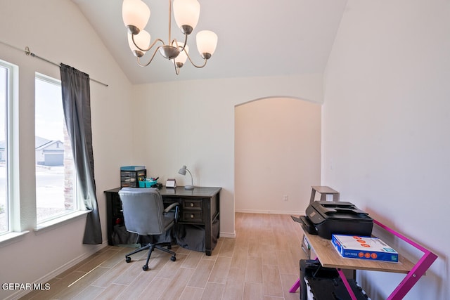 office with light hardwood / wood-style floors, vaulted ceiling, and a chandelier