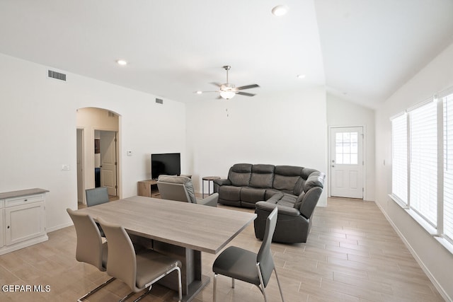 dining room featuring ceiling fan, lofted ceiling, and light hardwood / wood-style floors