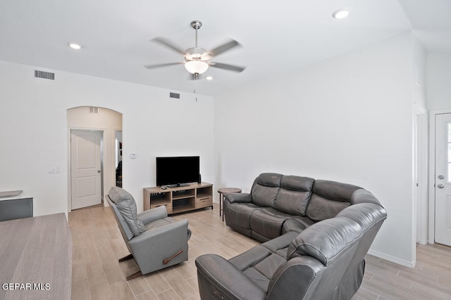 living room with light wood-type flooring and ceiling fan