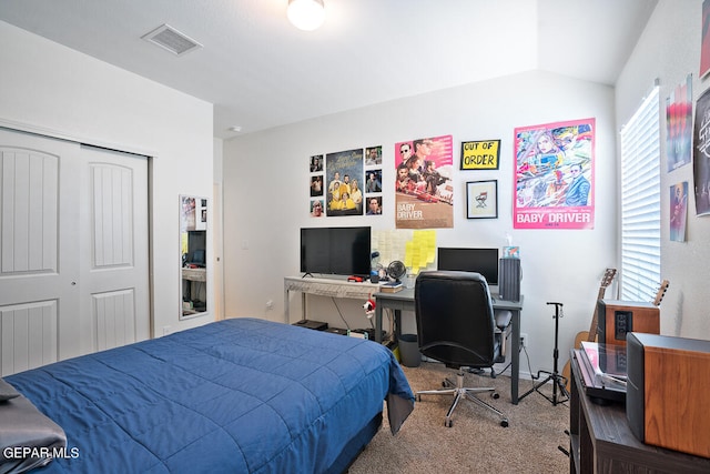 bedroom featuring a closet, vaulted ceiling, and carpet flooring