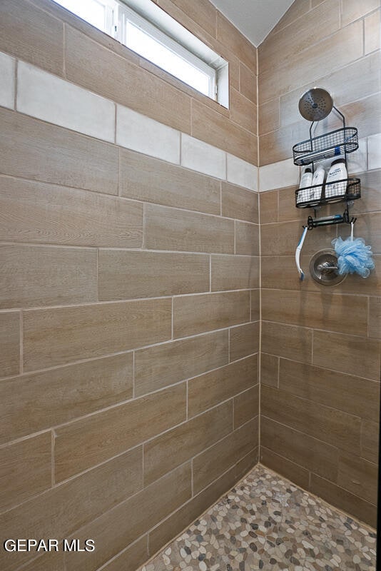 bathroom with a tile shower