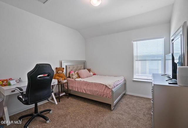 carpeted bedroom with lofted ceiling and multiple windows