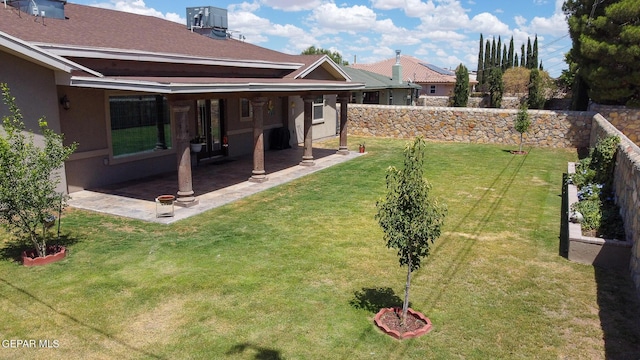 view of yard featuring a patio area, a fenced backyard, and central air condition unit