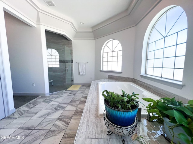 full bathroom with a healthy amount of sunlight, a stall shower, visible vents, and a garden tub