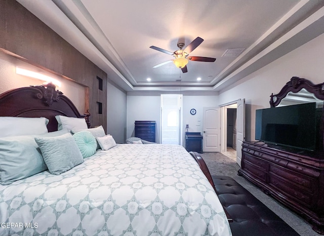 carpeted bedroom with a tray ceiling, recessed lighting, visible vents, and a ceiling fan