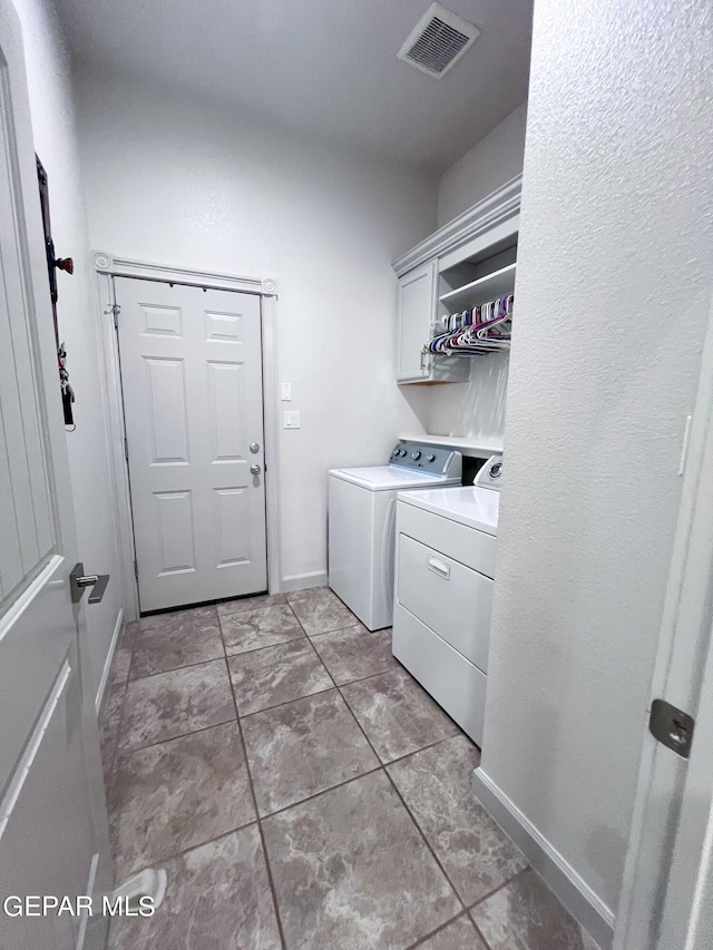 laundry area featuring laundry area, baseboards, visible vents, and washer and dryer