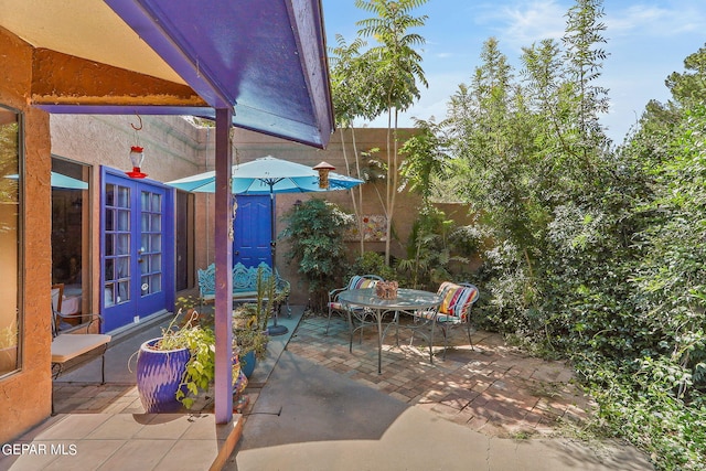 view of patio featuring outdoor dining area and french doors