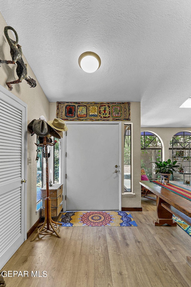 entrance foyer with a textured ceiling and wood finished floors