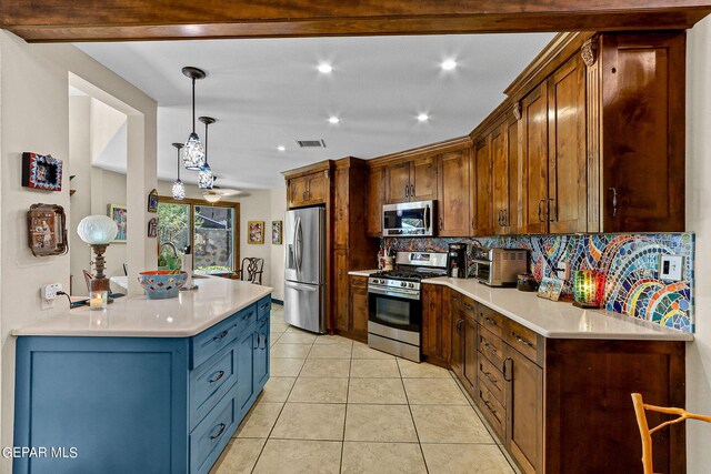 kitchen featuring decorative backsplash, light tile patterned floors, stainless steel appliances, and hanging light fixtures