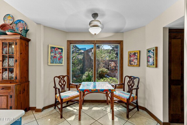 tiled dining room with ceiling fan