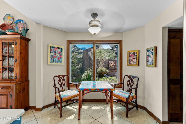 living area with light tile patterned floors and baseboards