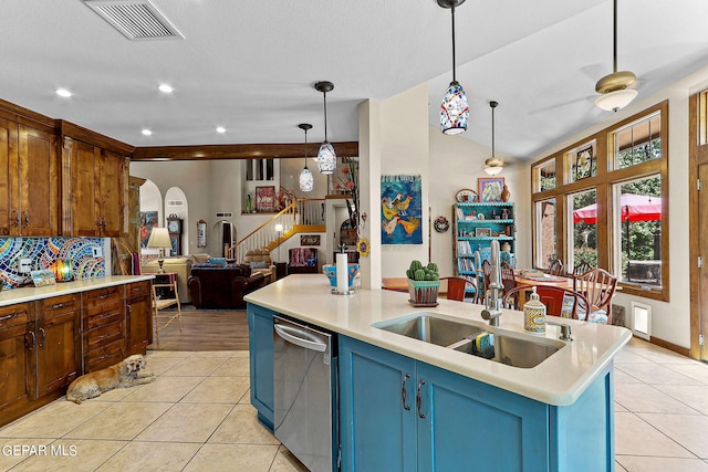 kitchen with light tile patterned floors, visible vents, arched walkways, dishwasher, and a sink