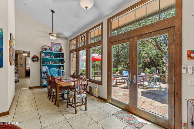 tiled dining room featuring ceiling fan and french doors