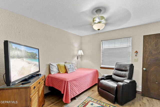 bedroom with ceiling fan and light wood-type flooring