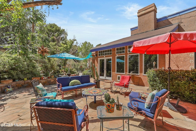 view of patio featuring an outdoor living space and french doors