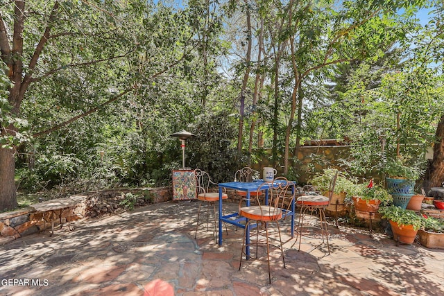 view of patio featuring outdoor dining space and fence