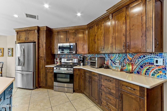 kitchen featuring light tile patterned floors, visible vents, appliances with stainless steel finishes, light countertops, and backsplash