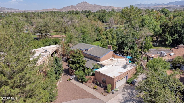 aerial view with a mountain view and a wooded view