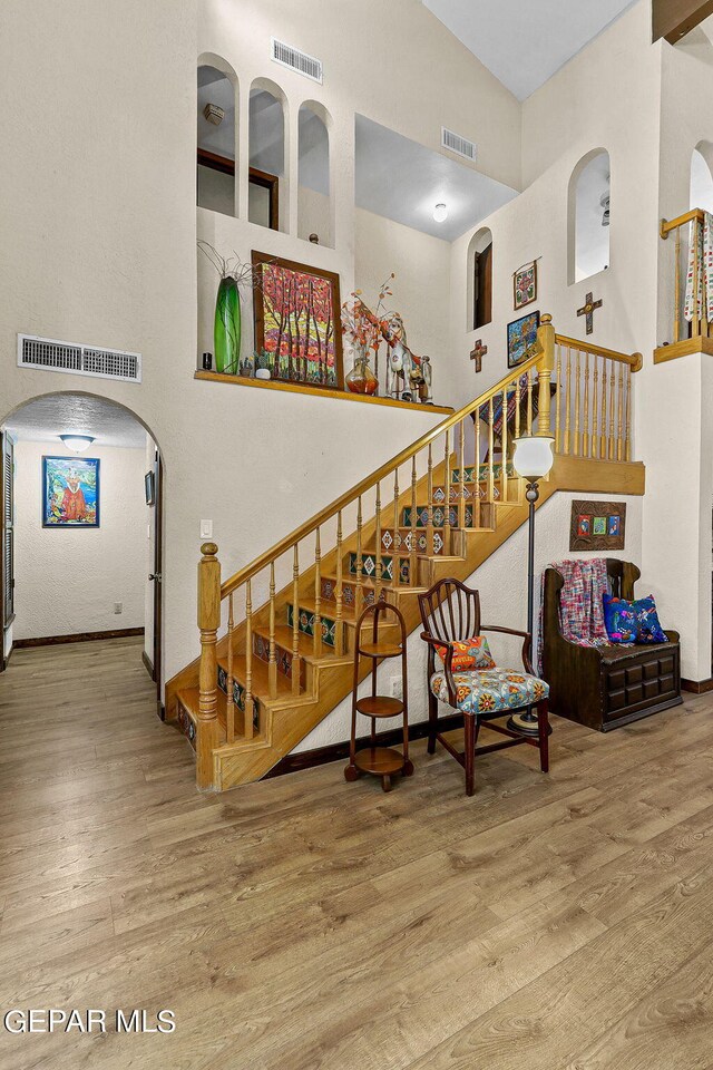 stairway featuring visible vents and wood finished floors