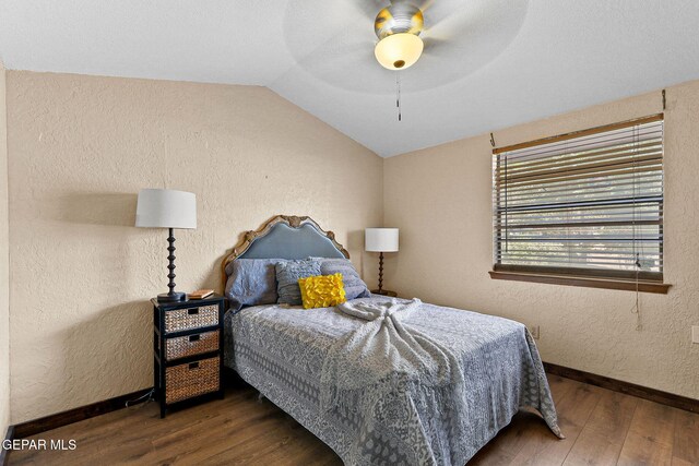 630 Gary Ln, El Paso, TX 79922 - bedroom featuring wood finished floors, vaulted ceiling, baseboards, a textured wall, and ceiling fan