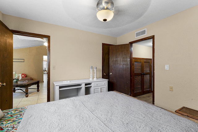 630 Gary Ln, El Paso, TX 79922 - bedroom with light tile patterned flooring, a ceiling fan, and a closet