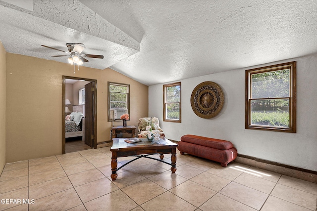 630 Gary Ln, El Paso, TX 79922 - living area featuring ceiling fan, a textured ceiling, lofted ceiling, and light tile patterned flooring