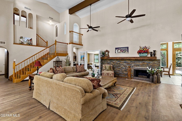 630 Gary Ln, El Paso, TX 79922 - living room with high vaulted ceiling, ceiling fan, wood finished floors, stairs, and arched walkways