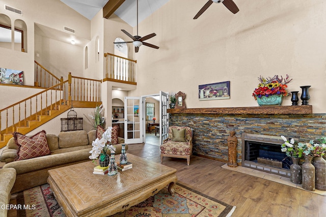 630 Gary Ln, El Paso, TX 79922 - living area with a ceiling fan, wood finished floors, stairs, a fireplace, and a towering ceiling