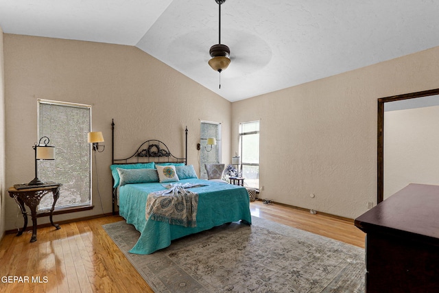 630 Gary Ln, El Paso, TX 79922 - bedroom featuring vaulted ceiling, a textured wall, light wood finished floors, and a ceiling fan
