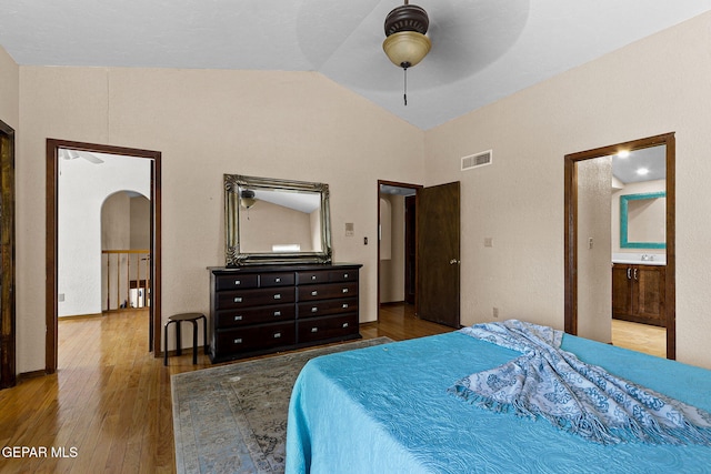 630 Gary Ln, El Paso, TX 79922 - bedroom featuring arched walkways, hardwood / wood-style flooring, high vaulted ceiling, ensuite bath, and a ceiling fan