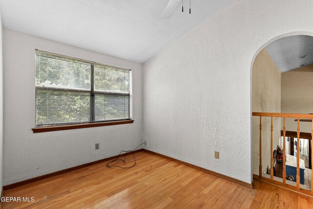 630 Gary Ln, El Paso, TX 79922 - unfurnished room featuring hardwood / wood-style flooring, a textured wall, lofted ceiling, ceiling fan, and baseboards