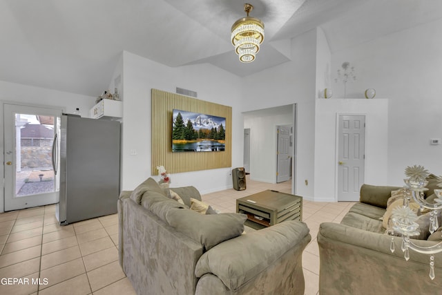 tiled living room featuring a notable chandelier and lofted ceiling