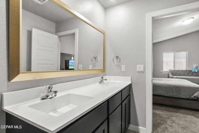 bathroom with vaulted ceiling and vanity