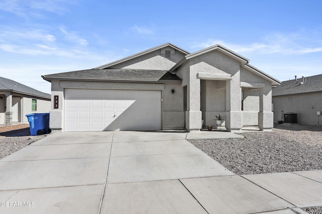 view of front of property with a garage and cooling unit