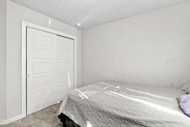 carpeted bedroom featuring a closet