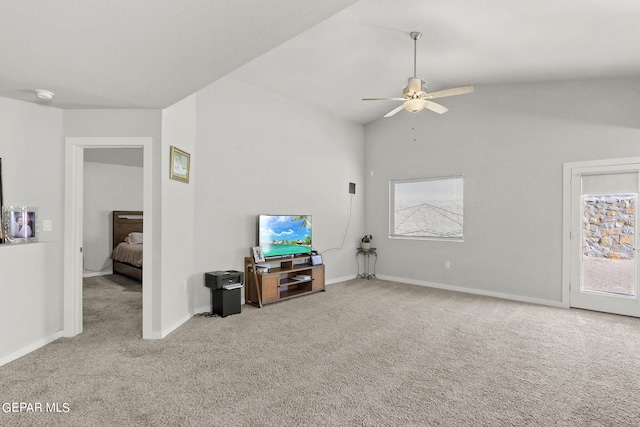 living room featuring ceiling fan, light carpet, and lofted ceiling