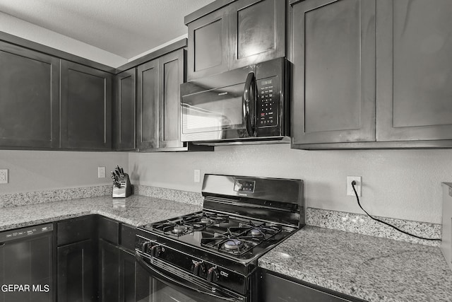 kitchen featuring a textured ceiling, light stone counters, and black appliances