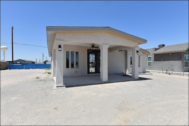 exterior space featuring stucco siding, ceiling fan, and a patio