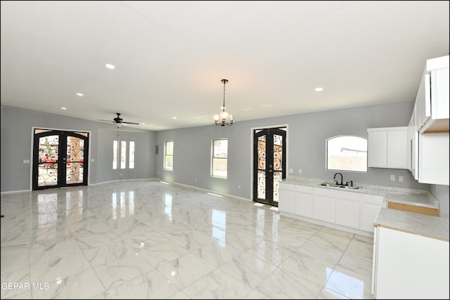 interior space with french doors, white cabinetry, and a healthy amount of sunlight