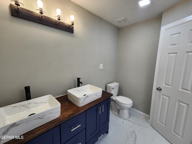 bathroom with tile patterned floors, toilet, and vanity