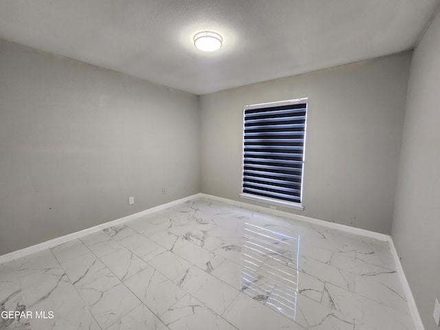 spare room with light tile patterned floors